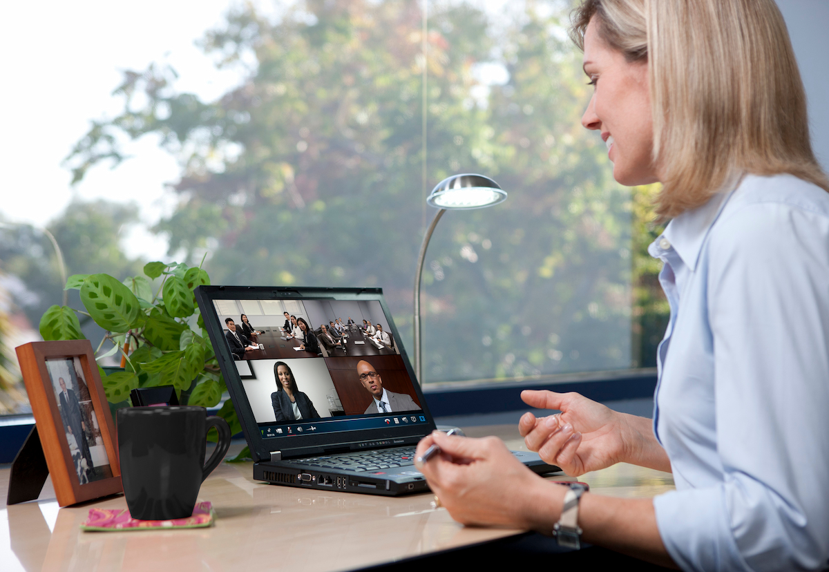 A photo of a woman at her laptop in an on online meeting